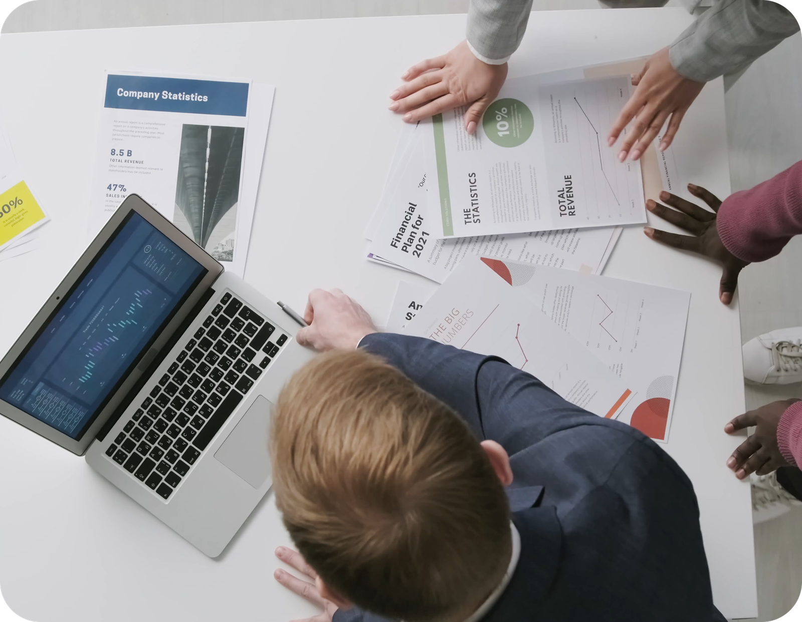 A team reviewing business reports and performance charts.